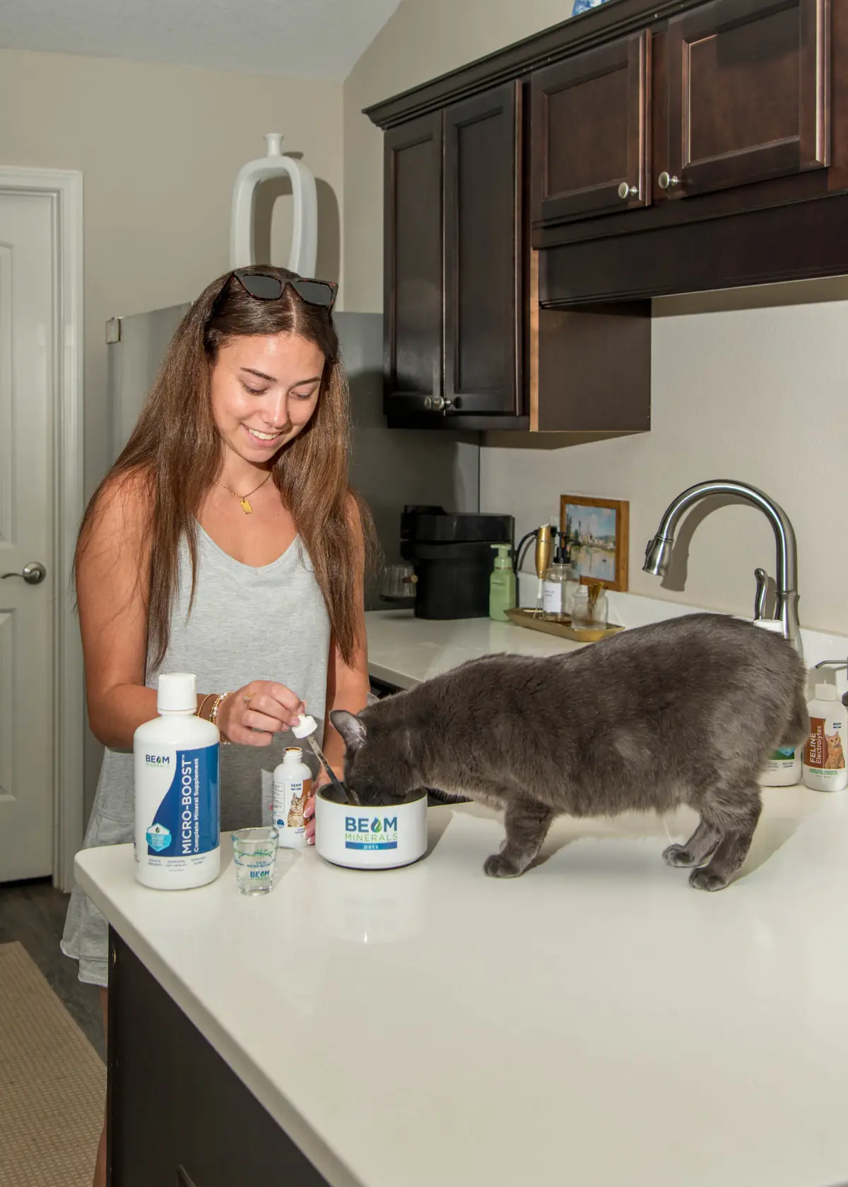 Woman preparing BEAM Minerals for her cat in the kitchen
